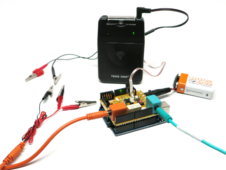 First, you need to set the frequency of the TENS device by sliding down the front face of the black TENS device: we set a ~50-80 ms pulse duration and a 10-20 Hz frequency.